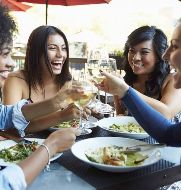 Group Of Female Friends Enjoying Meal At Outdoor Restaurant Group Of Female Friends Enjoying Meal At Outdoor Restaurant